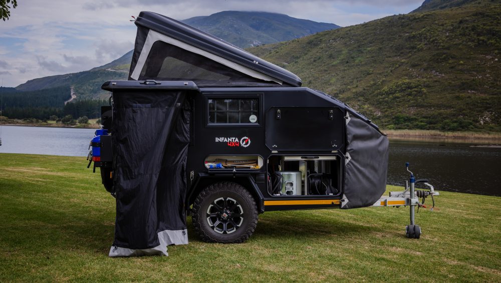 Side image of the Infanta 4x4 Enkulu 1 off-road caravan next to water in SOuth Africa