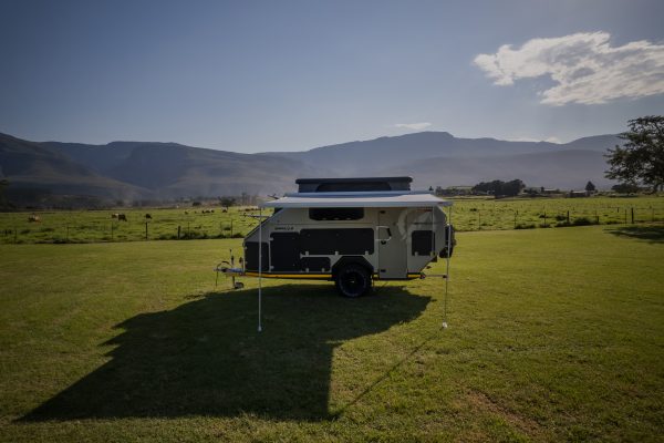 A zoomed out side photo of the Infanta 4x4 enkulu 2 camping caravan for sale in South Africa taken with a drone