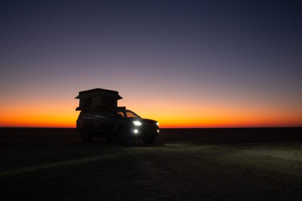 Buntutop tent from Bundutec on top of a bakkie on the beach in South Africa at night sunset